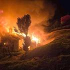 Firefighters work to extinguish a fire which tore through an Allandale Rd, Dunedin, house shortly...