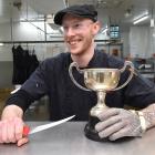 Gardens New World butcher Riley Hall, of Dunedin, with his trophy for winning the ANZCO Foods...