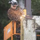 Construction workers begin the partial demolition and restoration of the historic Sims building,...