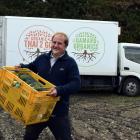 Organic Solutions director and co-founder James Porteous packs a truck with organic vegetables in...