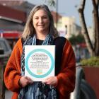 Dream South D project lead Rosie Hill shows one of 20 dots that will soon appear in South Dunedin...