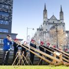 The Taranaki Swiss Club Alphorn Group performs in the Octagon, conducted by Alan Beck (below),...
