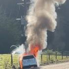 A hybrid car engulfed in flames on State Highway 88 between Dunedin and Port Chalmers yesterday...