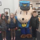 McKenzie Monaghan, 6 (left), Alexandra Monaghan, 6, Dog Man and Jack Monaghan, 7, pose for a...