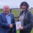 Gore Rotary Club president Russell Welsh gives Viv Beaton her $100 voucher from the MLT for being...