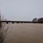A fast-flowing and swollen Motueka River under the State Highway 60 bridge between Riwaka and...