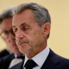 Former French President Nicolas Sarkozy reacts as he talks to journalists after the verdict in...