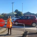 Waitākiri School Patrol member Zoe Simpson, 10, helps pupils, parents and caregivers cross safely...