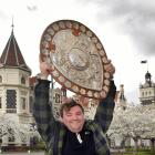 Rugby fan Joshua Stewart is all smiles with the Ranfurly Shield in Dunedin yesterday as he gets...