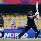 White Fern Sophie Devine plays a shot as Bangladesh wicket keeper Nigar Sultana Joty looks on....