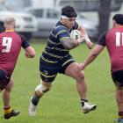 Otago Whalers forward Tofatuimoana Solia looks for a way through Southland defenders Calder White...
