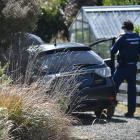Police search a spiked car in Strawberry Ln, off Upper Junction Rd in Roseneath. PHOTO: GREGOR...