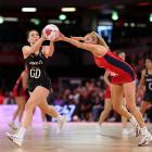 Silver Ferns goal defence Karin Burger catches the ball as England shooter Helen Housby comes...
