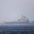 Chinese aircraft carrier Liaoning sails through the Miyako Strait near Okinawa on its way to the...