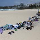 Belongings left behind by people are gathered at the beach near the scene of a shooting during a...