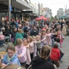 Children form a train as they dance during New Year's Eve celebrations at George St. Photo:...