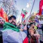 Demonstrators wave flags outside the Iranian Embassy in London during a rally in support of the...