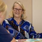 Grandees founder Wendy Nuthall helps a St Albans School pupil with their reading. Photo: Geoff Sloan