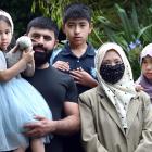 Told to go, then allowed to stay, are the Hussan family (from left) Sumi, 4, Muhammad, Oumaier,...