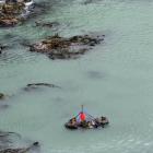 A helicopter winches John Beckenridge’s car from the ocean in May 2015. Photo: Stephen Jaquiery