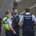 Police stand outside the Dunedin Courthouse after a defendant allegedly physically lashed out at...