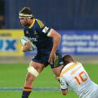 Highlanders lock Tom Franklin tries to slip past Chiefs first five Aaron Cruden during a game in...