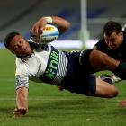 Crusader David Havilli tries to stop Caleb Clark from scoring one of three tries during Saturday...