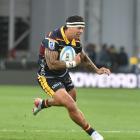 Highlanders centre Jonah Lowe looks for space during the Super Rugby Pacific season opener...