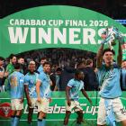 Nico O'Reilly lifts the Carabao Cup after scoring a double in Manchester City's final win. Photo:...