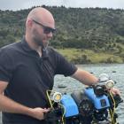 UWAI Robotics co founder Tim Rensen deploying the underwater drone to scan mussel lines on a farm...