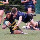 Rangiora High School first XV player Suliasi Uhatafe is tackled during the championship rugby...