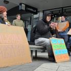 Chris Ford (with the megaphone) leads the chanting at a protest on Saturday against the...