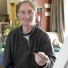 Evansdale artist Greg Abbott puts the finishing touches on his latest artwork from his left...