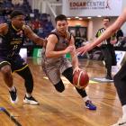 Southland Sharks guard Rylan Jones looks for a way around Otago Nuggets point guard Alain Louis...