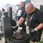 Eddie Coetsee tends to his brisket while team-mate Russell Lovatt looks on during the Deep South...