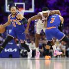 New York Knicks guard Jalen Brunson works his way around team-mate Josh Hart and Philadelphia...