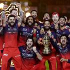 Jacob Duffy, behind Virat Kohli (with arms raised), and the Royal Challengers Bengaluru team...