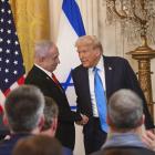 Israeli Prime Minister Benjamin Netanyahu (L) and US President Donald Trump (R) and (L) shake...