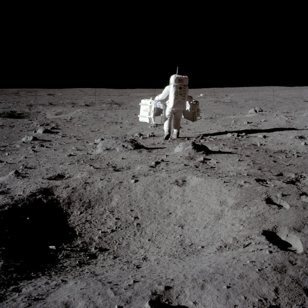 Buzz Aldrin carries equipment for experiements carried out at Tranquility Base in the Sea of...