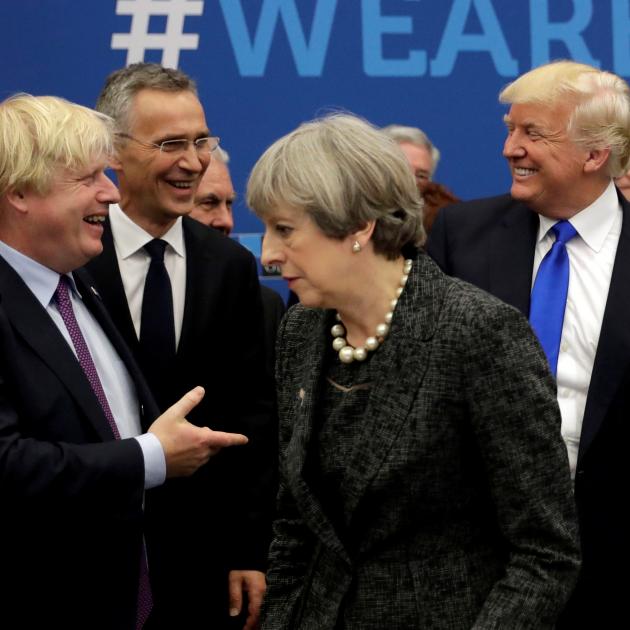 Boris Johnson greets Donald Trump at a Nato meeting in 2017, with Prime Minister Theresa May....