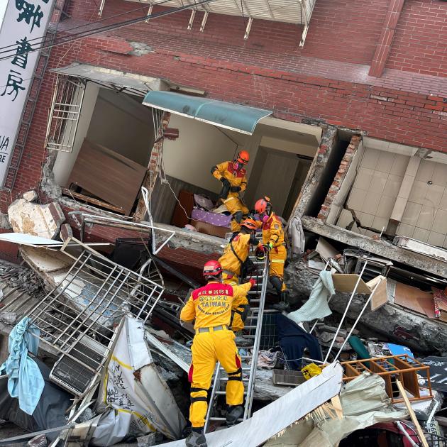 Firefighters work at a collapsed building in Hualien following Wednesday's quake. Photo: Taiwan...