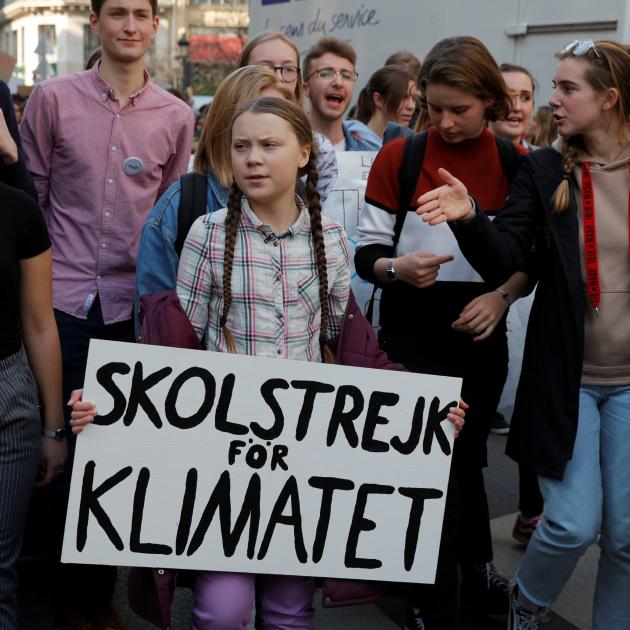 Swedish environmental activist Greta Thunberg (16, centre) takes part in a protest calling for...