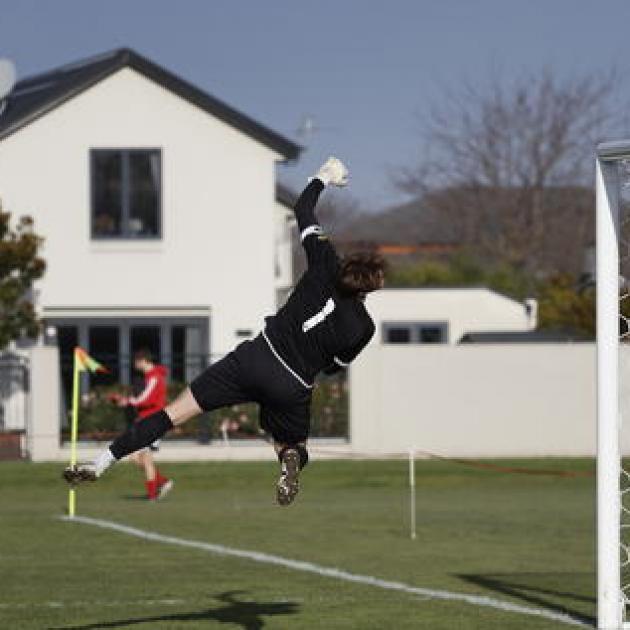 Matt Foord dives to tip a shot over the bar. PHOTO: MITCHELL COZZONE/DUST.MEDIA