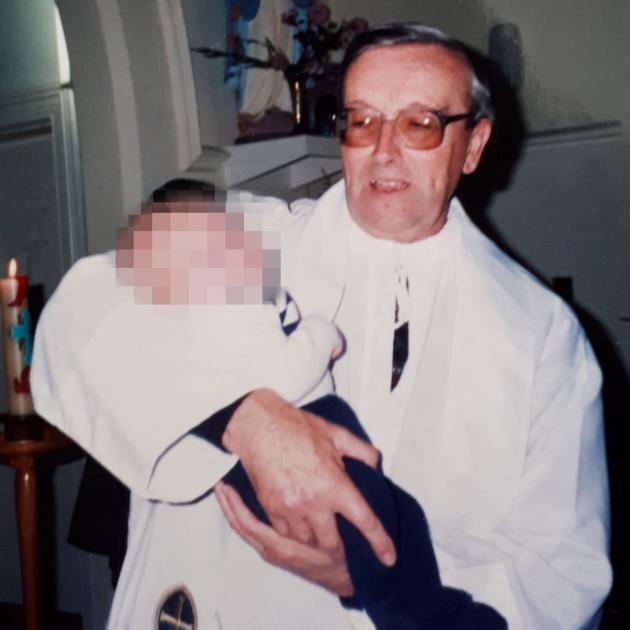 Fr Murray baptising one of Paula's children. Photo: supplied 