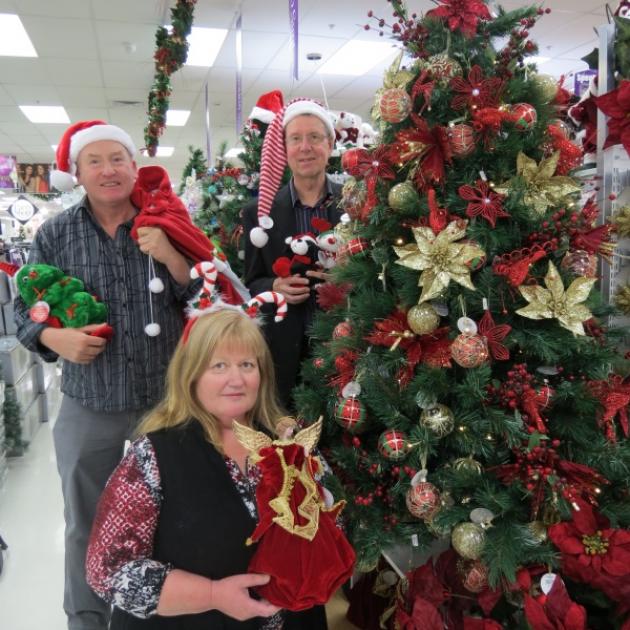 Getting into the Christmas spirit, with a little help from the friendly folk at  Farmers, are Dunedin Council of Social Services executive officer Alan Shanks (back right) and Dunedin  Community Christmas Dinner organisers Grant and Anne Hardy. Photo by B