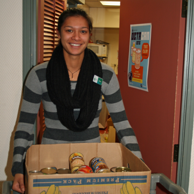 Boxing up some of the 794 cans of  food already donated for next Thursday’s Octacan event is  Presbyterian Support Otago Family Works community  development worker Preeti Aryal. Photo by Su Anderson