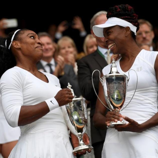 Serena (left) and Venus Williams have a perfect 14-0 record in grand slam doubles finals. Photo: Reuters 
