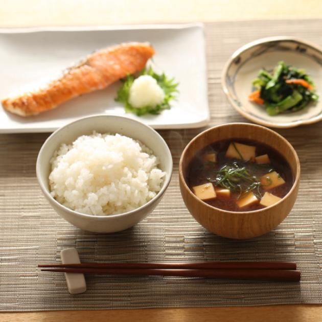 A hearty Japanese breakfast consisting of miso soup with tofu and scallions, salmon, rice and pickles. Photo: iStock kazoka30