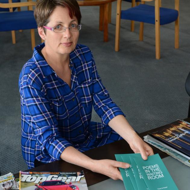 Ruth Arnison, editor for Poems in the Waiting Room, tops up the supply of poetry cards at a laboratory waiting room in Dunedin. The charity has placed 127,000 cards in waiting rooms in the past eight years. Photo: Linda Robertson.