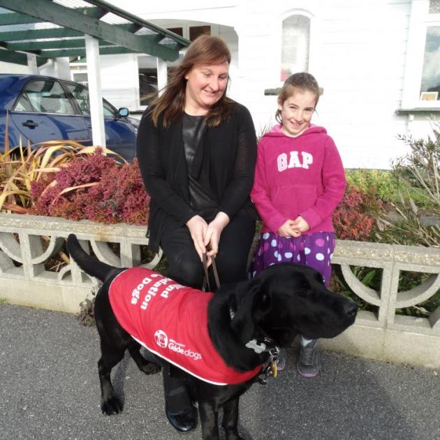 Guide dog-in-training Bessie soaks up the sun with her boarder Celia and Claudia (7) Hepburn. PHOTO: ELEANOR AINGE ROY